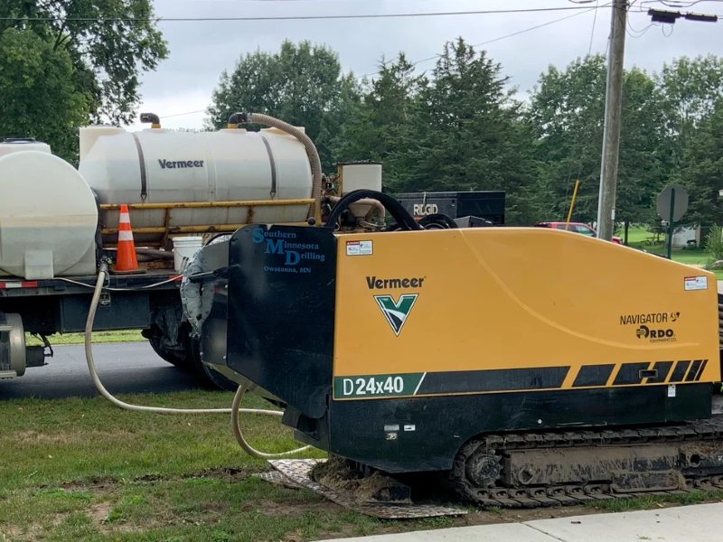 Horizontal directional drilling rig boring under a road verge